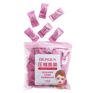 Bioaqua compressed face masks packaging with pink masks on a white background