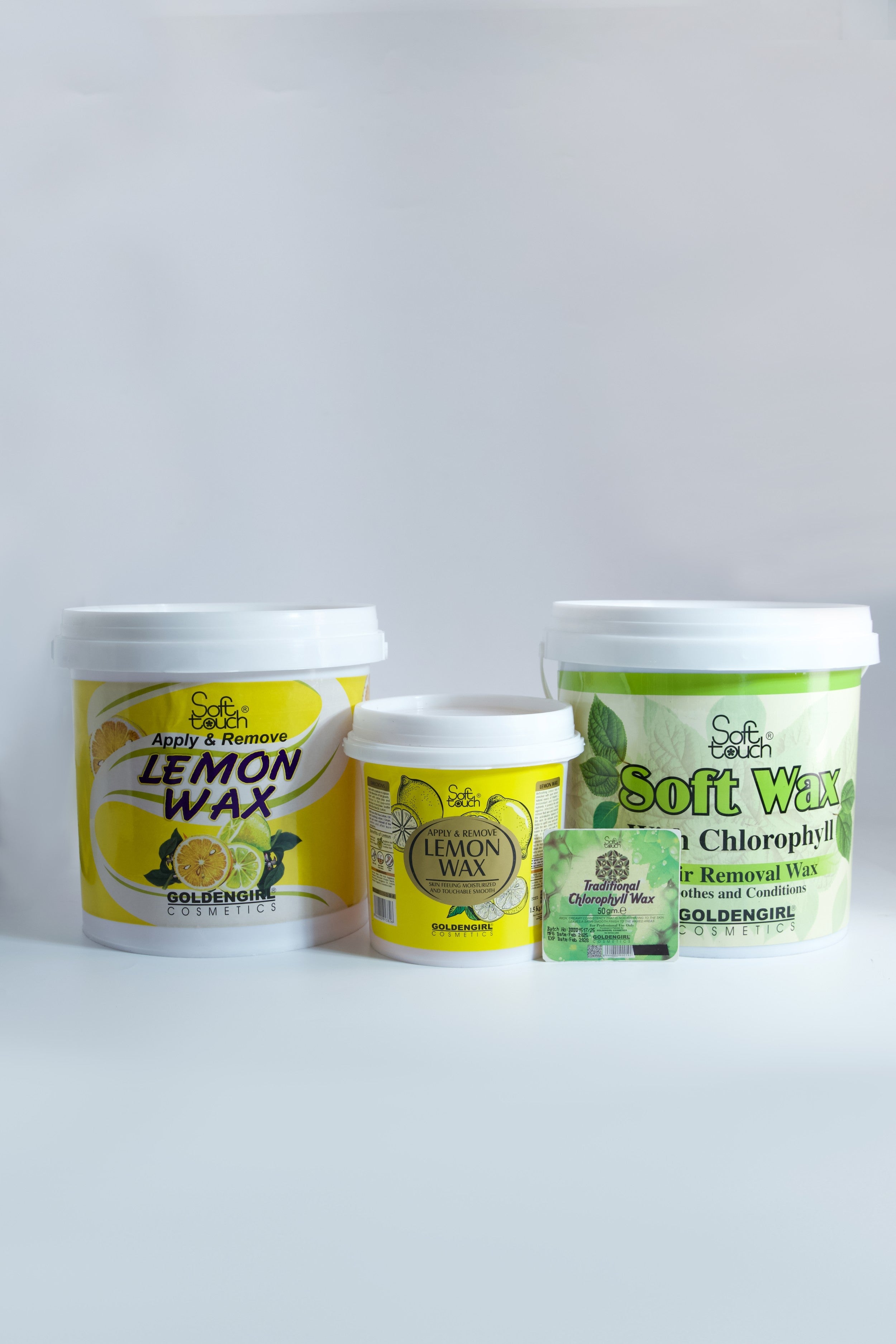 Three containers of lemon wax and soft wax on a white background