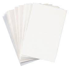 Stack of white end papers for hair salons.